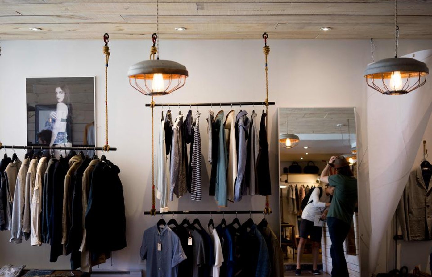 A rack of clothing in a bright room